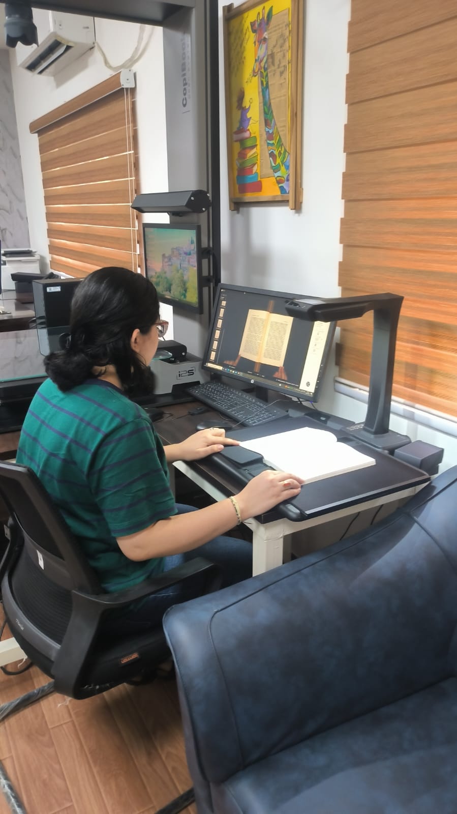 Student capturing and reviewing a digitised book page at the Centre scanner